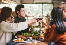 Dinner with friends. Group of young people enjoying dinner together. Dining Wine Cheers Party thanksgiving Concept