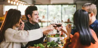 Dinner with friends. Group of young people enjoying dinner together. Dining Wine Cheers Party thanksgiving Concept