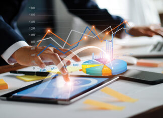 Businessman using tablet and laptop analyzing sales data and economic growth graph chart. Business strategy. Digital marketing. Business innovation technology concept