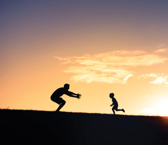 Father and son having fun in the park.