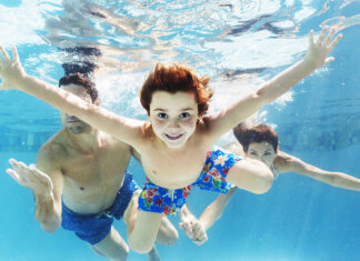 Family swimming in pool