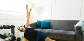 Fitness young man training at his home gym