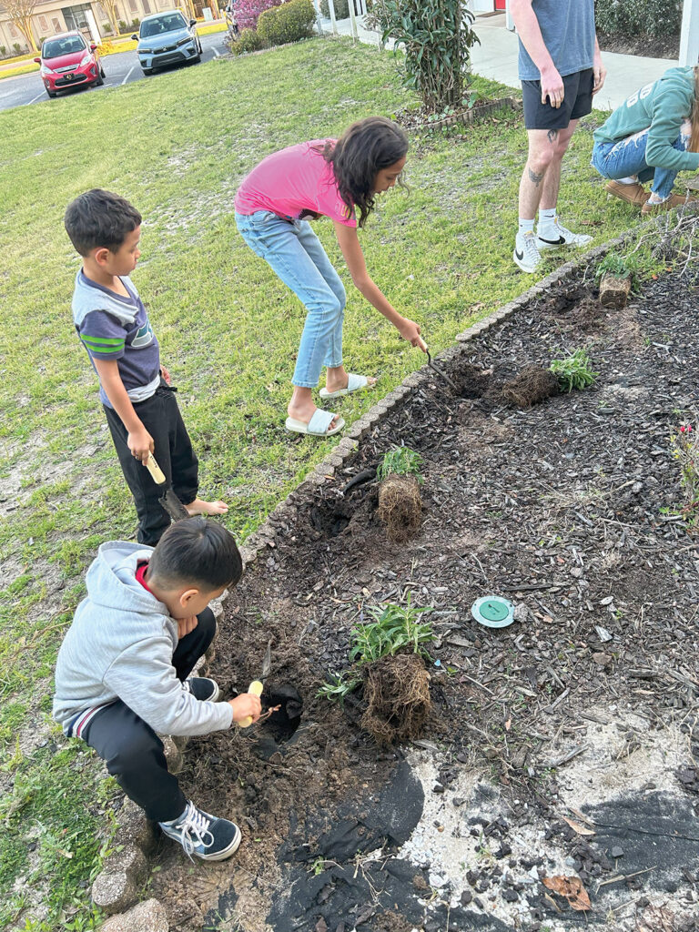 Opportunity Place kids planting